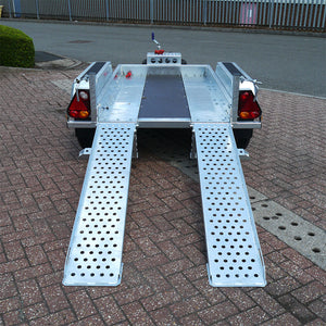 Back view photo of a micro digger trailer with ramps extended